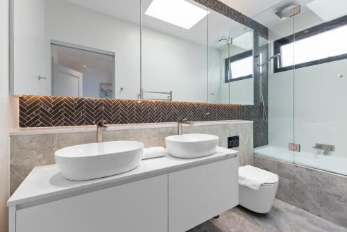 two sinks on a counter in a bathroom at Spacious Family-Friendly 5-BR Home in Glebe in Sydney