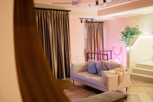 a living room with a couch and a chair at Tere Home Landed Stylish&Warm Flamingo Pinky House in Shah Alam