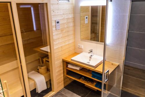 a bathroom with a sink and a shower at Biobauernhof Jagglhof in Saalfelden am Steinernen Meer
