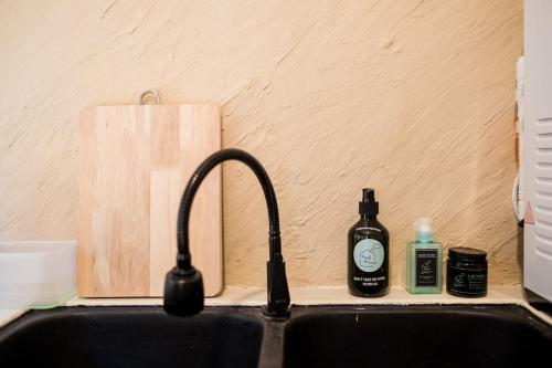 a kitchen sink with a faucet and two bottles of soap at Tere Home Landed Stylish&Warm Flamingo Pinky House in Shah Alam