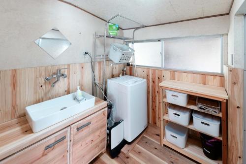 a bathroom with a sink and a washing machine at Casa de Mano - Vacation STAY 21638v in Mihara
