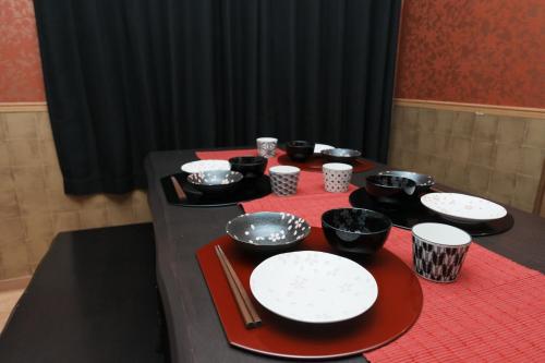 a table with plates and bowls on top at Prosper 5th bldg 501 in Nagoya
