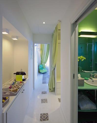 a hallway of a bathroom with a sink and a tub at Casa Marta Capri in Capri