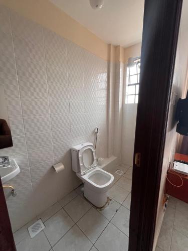 a bathroom with a toilet and a sink at Pearl Studio in Machakos