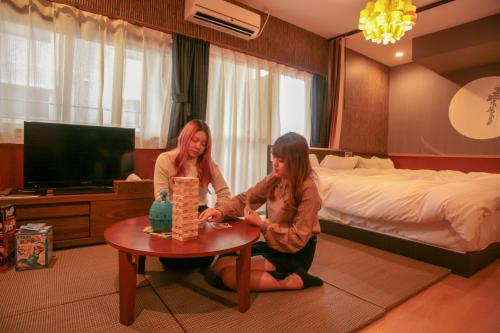 two girls are sitting around a table in a hotel room at Prosper 5th bldg 501 in Nagoya