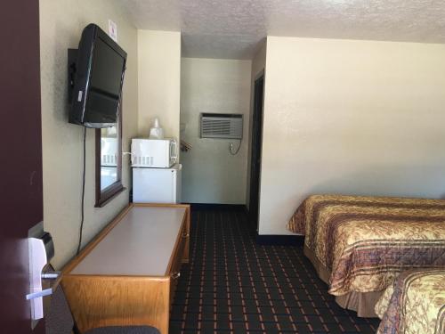 a hotel room with two beds and a flat screen tv at Best Value Inn Motel Sandusky in Marianna