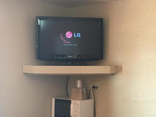 a tv sitting on a shelf in a room at Best Value Inn Motel Sandusky in Marianna