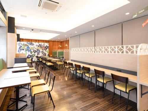 a row of tables and chairs in a restaurant at Comfort Hotel Naha Prefectural Office in Naha