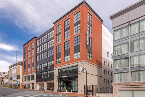 a large brick building on a city street at Cambria Hotel Portland Downtown Old Port in Portland