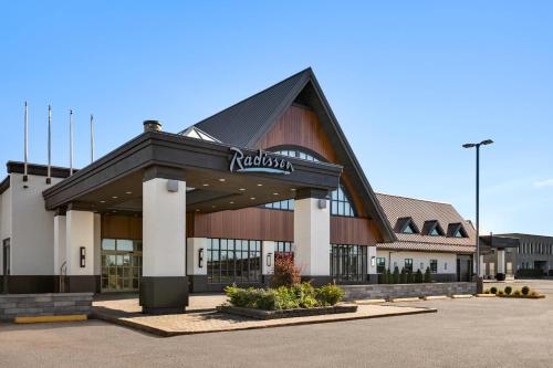 a building with a sign on the front of it at Radisson Hotel Montreal Airport in Saint-Laurent