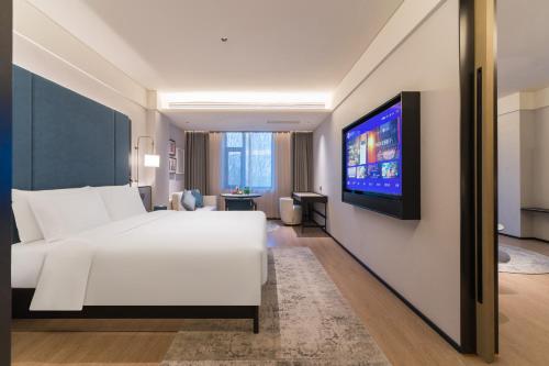 Una cama o camas en una habitación de Manxin Hotel, Guilin Road, Changchun Zoo and Botanical Garden