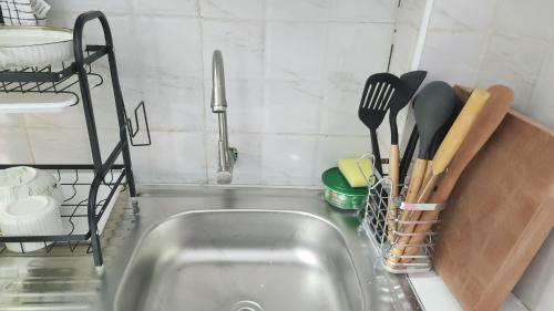 a kitchen sink with utensils in a kitchen at Naivasha Naivegas C5 Staycation by Charlie izzy in Munyu