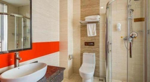 a bathroom with a toilet and a sink and a shower at 7 Days Premium·Hotel Pei County Longcheng International in Datun