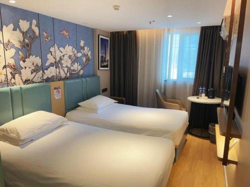 Ένα ή περισσότερα κρεβάτια σε δωμάτιο στο 7Days Inn Xuzhou Normal University Yunlong Mountain