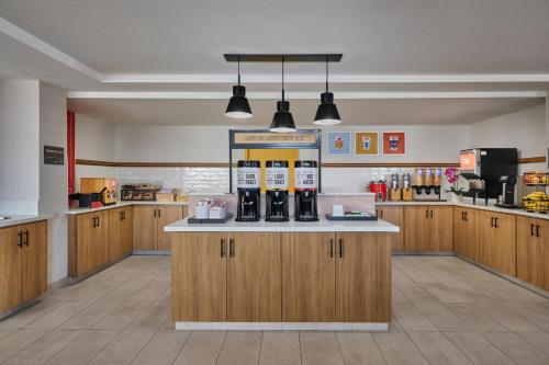 a kitchen with wooden cabinets and a counter with wine bottles at Hampton Inn & Suites Hermosa Beach in Hermosa Beach