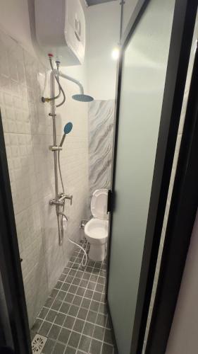 a bathroom with a shower with a toilet in it at Ndalem Argupta in Kalibeber