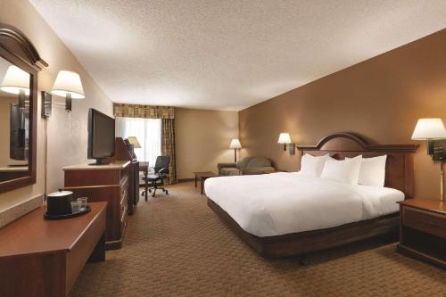 a hotel room with a bed and a television at Comfort Inn & Suites Portland - Corpus Christi in Portland