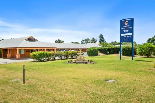 a building with a sign in front of a park at Comfort Inn Bishops Lodge in Hay