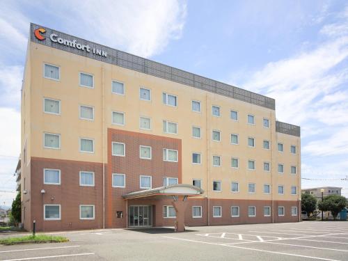 a building with a sign on the top of it at Comfort Inn Kumamoto Miyukifueda in Kumamoto
