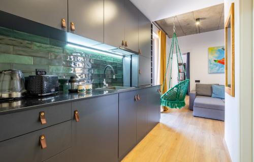 a kitchen with grey cabinets and a couch in a room at New Gudauri Twins in Gudauri