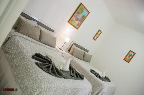 a bedroom with a bed with a towel on it at Batey Hotel Boutique in Boca Chica