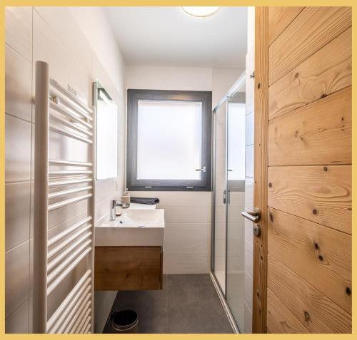 a bathroom with a sink and a window at L'évasion I T3 I Les Gets in Les Gets