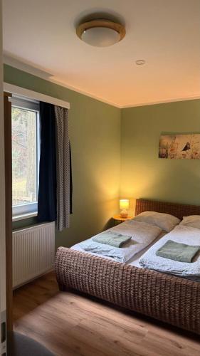 a bedroom with two beds and a window at Ferienhaus Drossel am Teutoburgerwald in Lage