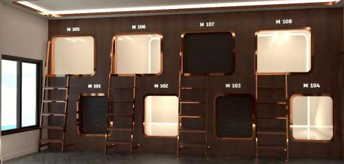 a wall of windows in a room with ladders at The Rich Cafe & Hostel in Pattaya South