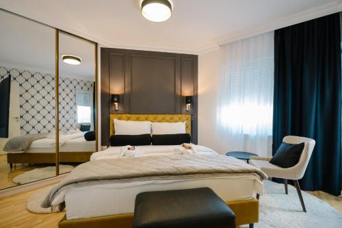 NAR Royalton Deluxe Apartment #63 في نيشْ: غرفة نوم بها سرير كبير وكرسي