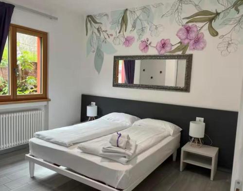 Ένα ή περισσότερα κρεβάτια σε δωμάτιο στο Villa Teresa - Appartamenti con vista lago