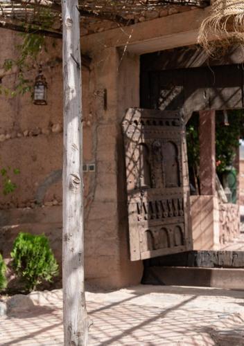 a porch of a building with a wooden door at Atlas Aura Hotel Ourika - Marrakech in Agadir nʼTafent