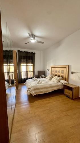 a bedroom with a large bed and a ceiling fan at Galteo Remedios in Ronda