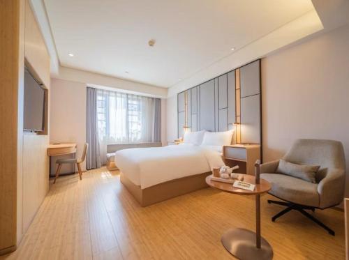 Postel nebo postele na pokoji v ubytování JI Hotel Chengdu East Railway Station