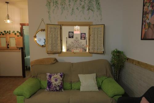 a living room with a couch with pillows on it at El Retoño in El Bosque