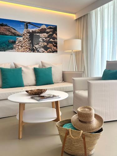 a living room with a couch and a table at Apartamentos Llobet Ibiza in Ibiza Town