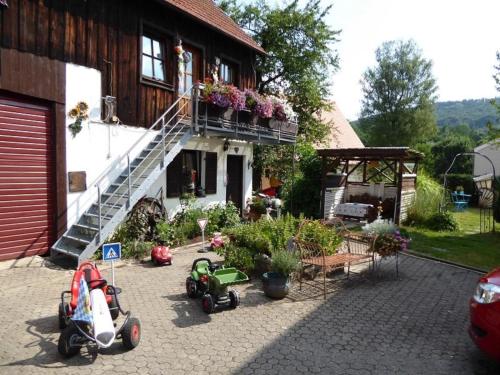 a house with some toy cars parked in front of it at Ferienhof Haus Sulztal in Berching