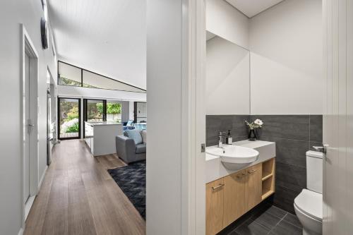 a bathroom with a sink and a toilet in a room at Forest Getaway - walk to Margaret River town - NEW in Margaret River Town