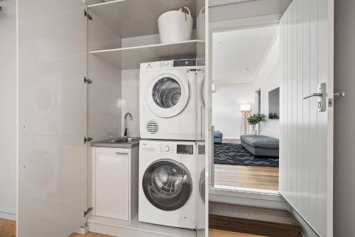 a laundry room with a washer and dryer in it at Forest Getaway - walk to Margaret River town - NEW in Margaret River Town