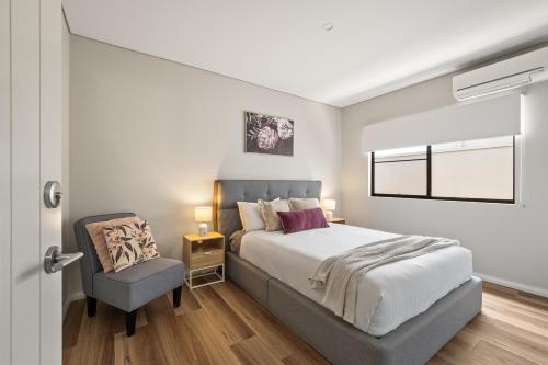 a bedroom with a bed and a chair at Forest Getaway - walk to Margaret River town - NEW in Margaret River Town