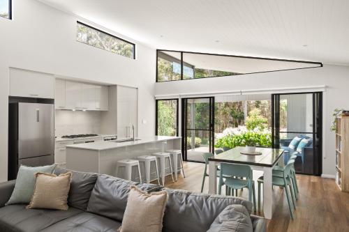 a living room with a couch and a table at Forest Getaway - walk to Margaret River town - NEW in Margaret River Town