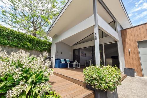 a home with a wooden porch with plants at Forest Getaway - walk to Margaret River town - NEW in Margaret River Town