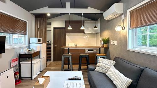 a living room with a couch and a kitchen at Solana富士御殿場 in Gotemba