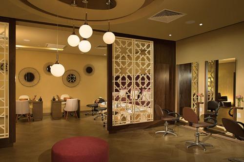 a salon with a red chair and a red stool at Dreams Jade Resort & Spa - All Inclusive in Puerto Morelos