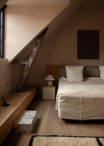 a bedroom with a large bed and a staircase at Audo Boutique Hotel in Copenhagen