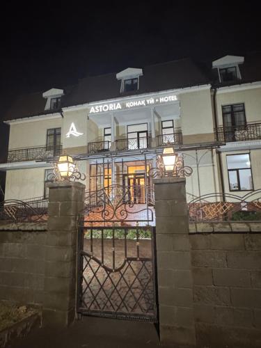 a building with a gate in front of it at night at Hotel Astoria in Astana