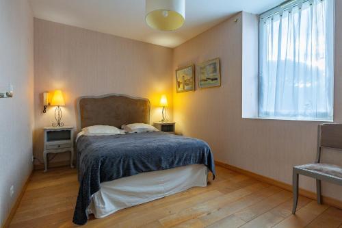 En eller flere senge i et værelse på Gîte La Ferme De Musan