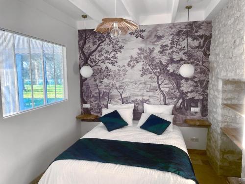 Ένα ή περισσότερα κρεβάτια σε δωμάτιο στο Domaine des Anes - Gite des Mûriers