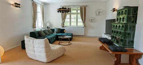 a living room with a couch and a chair at Forsthaus Faistenau in Hintersee