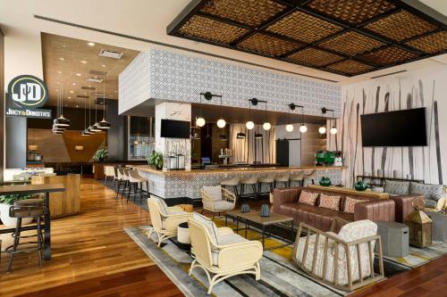 a lobby of a hotel with a bar and chairs at The Westin Phoenix Downtown in Phoenix