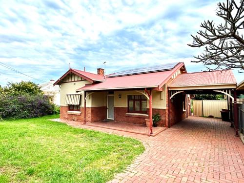 a house with a red roof and a brick driveway at 3BR Guest House near Adelaide CBD Joslin 5070 in Evandale